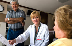 Elderly couple speaking to physician