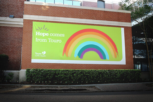 hope banner with rainbow on a brick wall